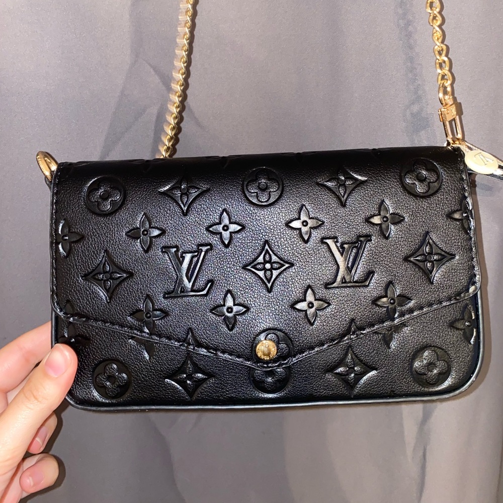 Black crossbody with gold chain and red interior
